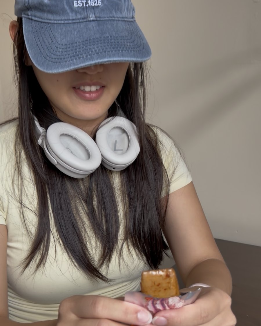 Stacie, co-founder and food scientist, eating a cube of seasoned tofu