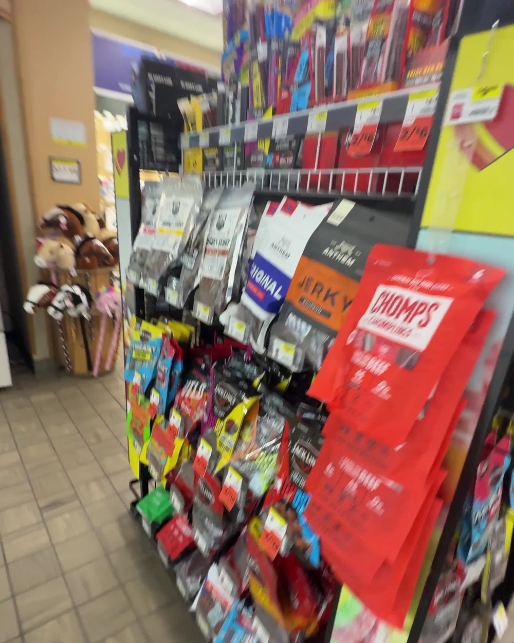 A gas station meat snack rack packed with jerky and meat sticks